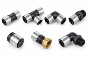 Black fittings with silver sleeves: couplings, a tee, elbows, threaded adaptors, end plugs and a swivel with a brass nut.
